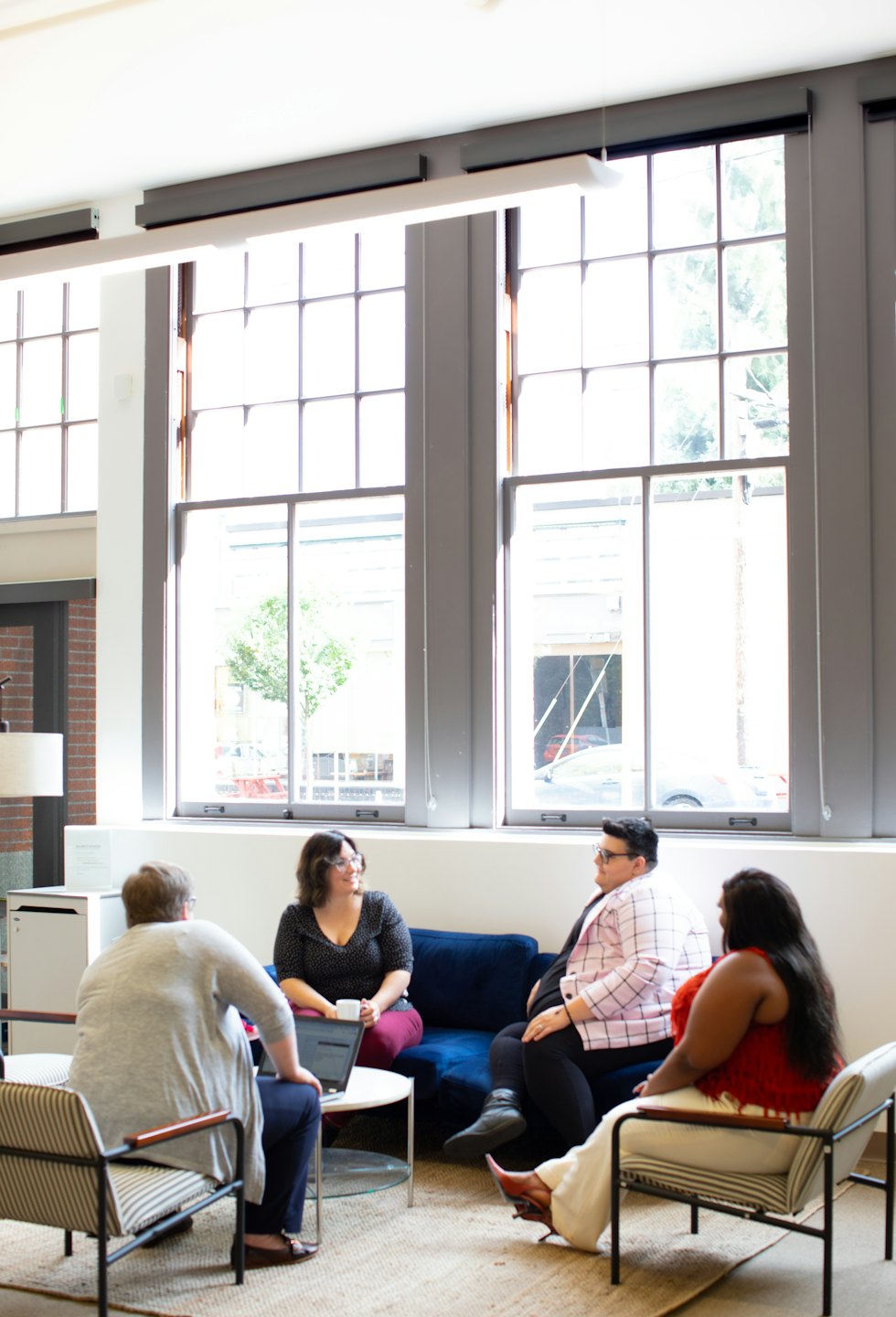 Diverse professionals collaborating in a modern office lounge.